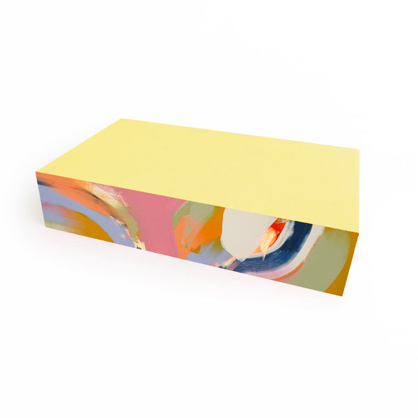 Medium Canary Swirl Pad notepad by Moglea with vibrant yellow and orange swirling design on textured paper.