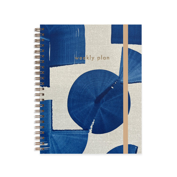 Indigo A5 weekly undated planner notebook by Moglea with a sleek cover and organized pages for scheduling and note-taking.